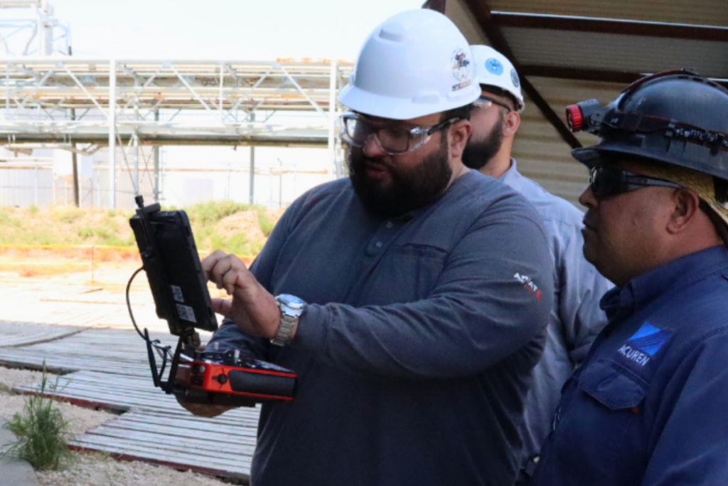 Inspection professionals evaluating industrial technology at an MFE event in Pasadena