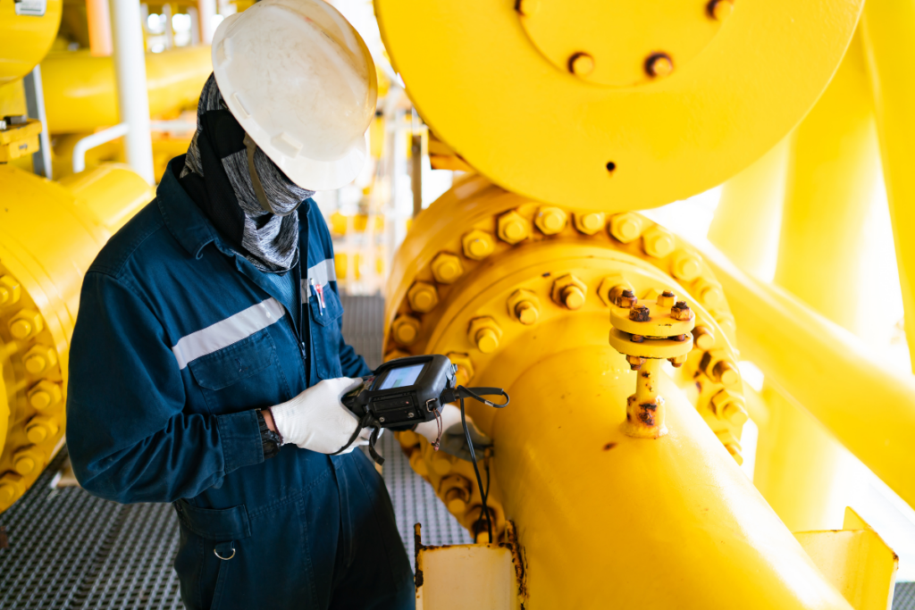 Inspector examining piping at a utility facility